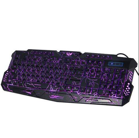 Gaming keyboard with LED backlighting in red on desk with mouse and headphones